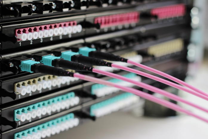 Fiber patch panel with black metal frame, front panel with multiple LC interfaces arranged neatly, fiber jumpers connected at back